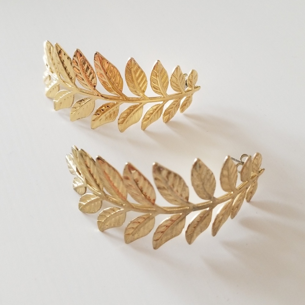 Gold feather statement earrings